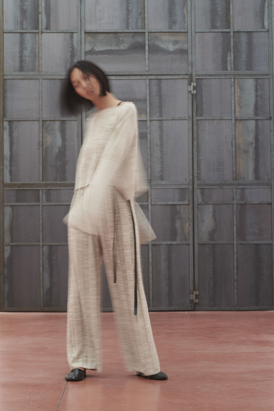 out of focus photo of a model dressing a 100% cashmere dress